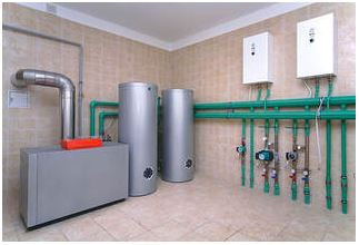 Boiler heating room showing two water heater, furnace, piping mounted on wall with various valves and panels.